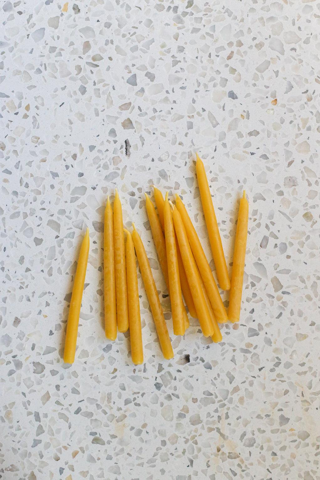 Beeswax birthday candles on terazzo