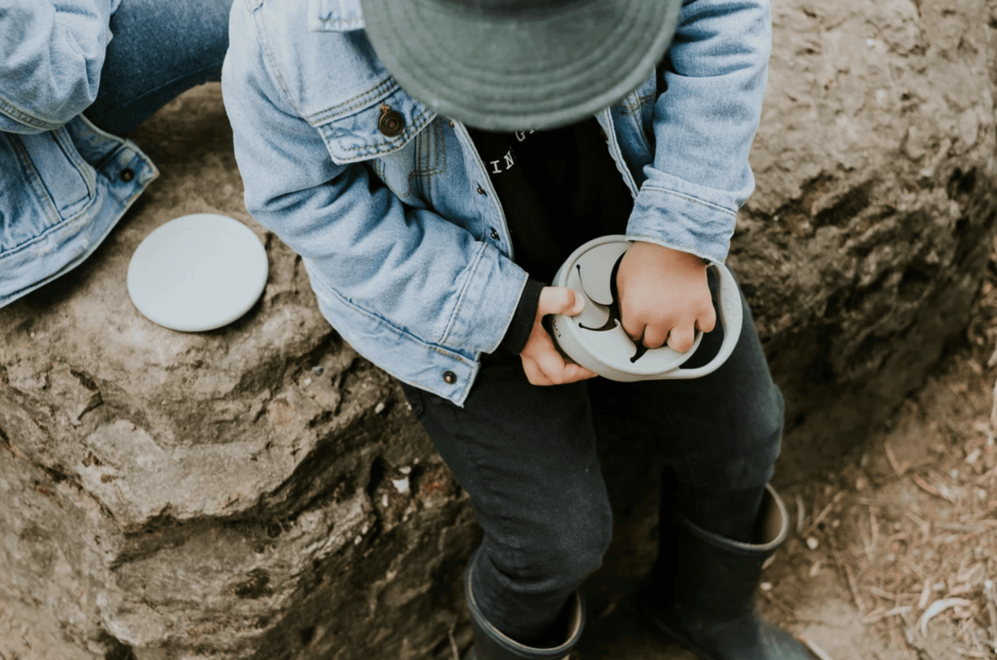 toddler using a minika snack cup