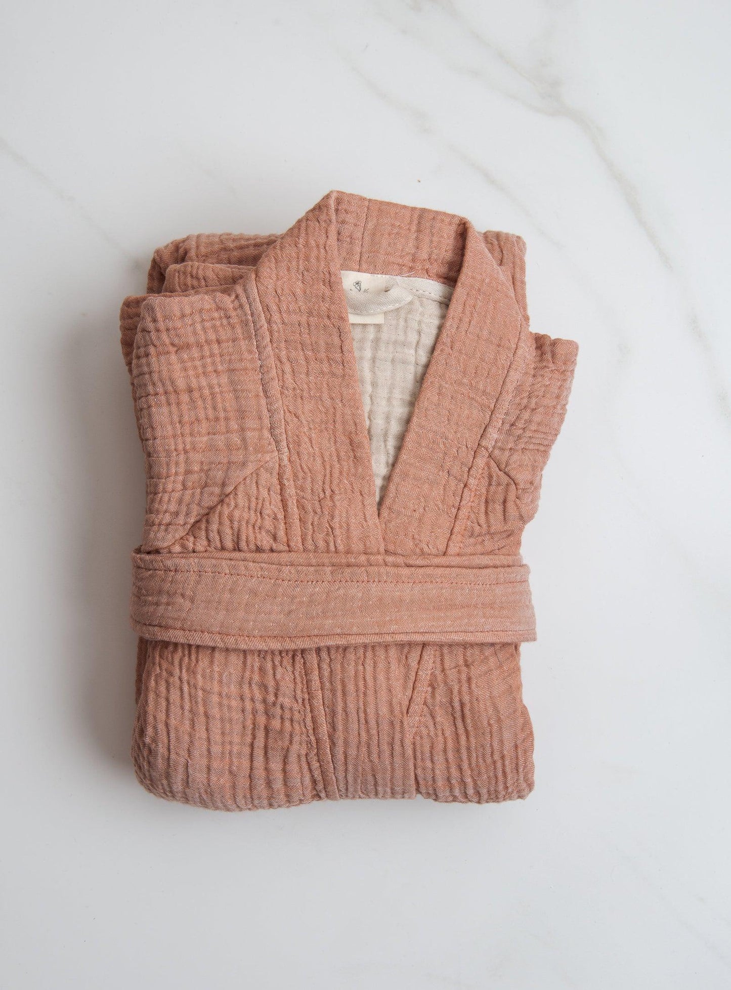 pink loungewear folded on a white surface