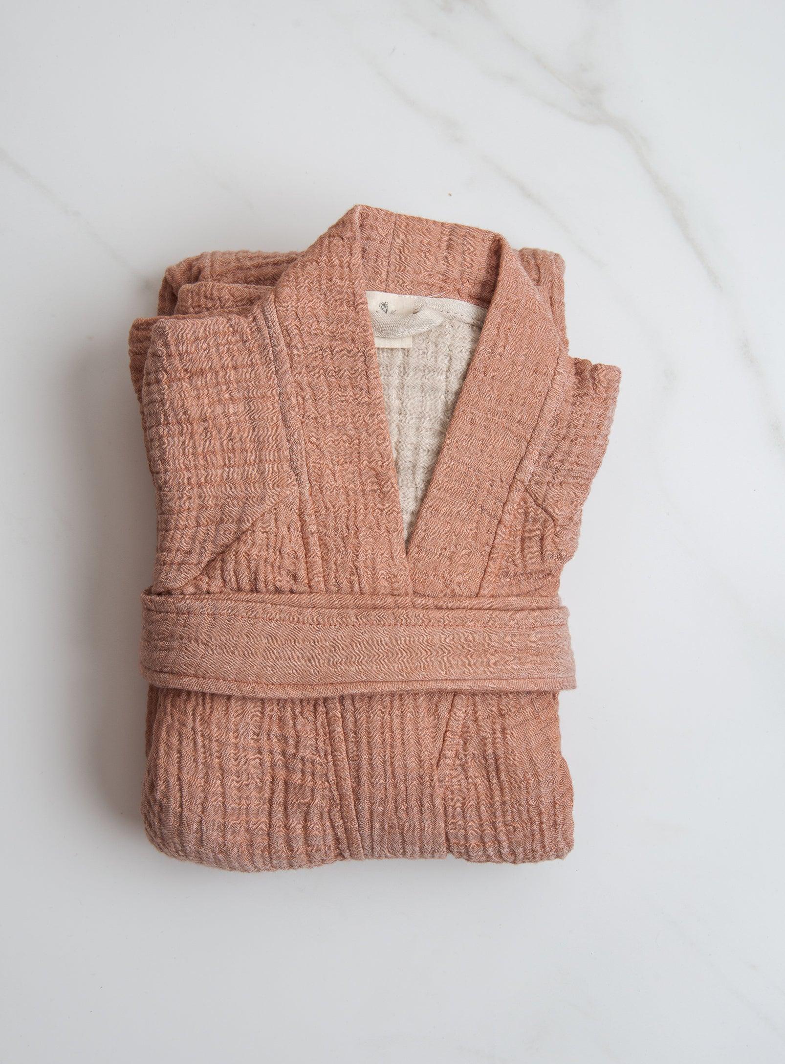 pink loungewear folded on a white surface
