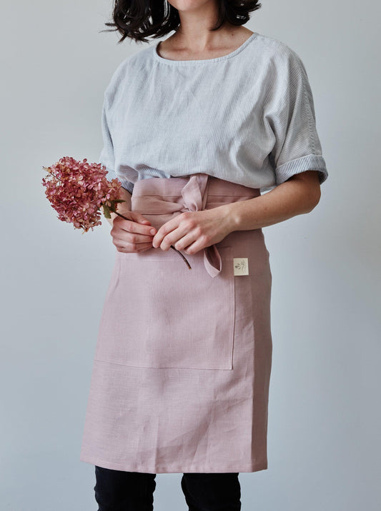 Front of our dusty rose linen half apron with large pocket