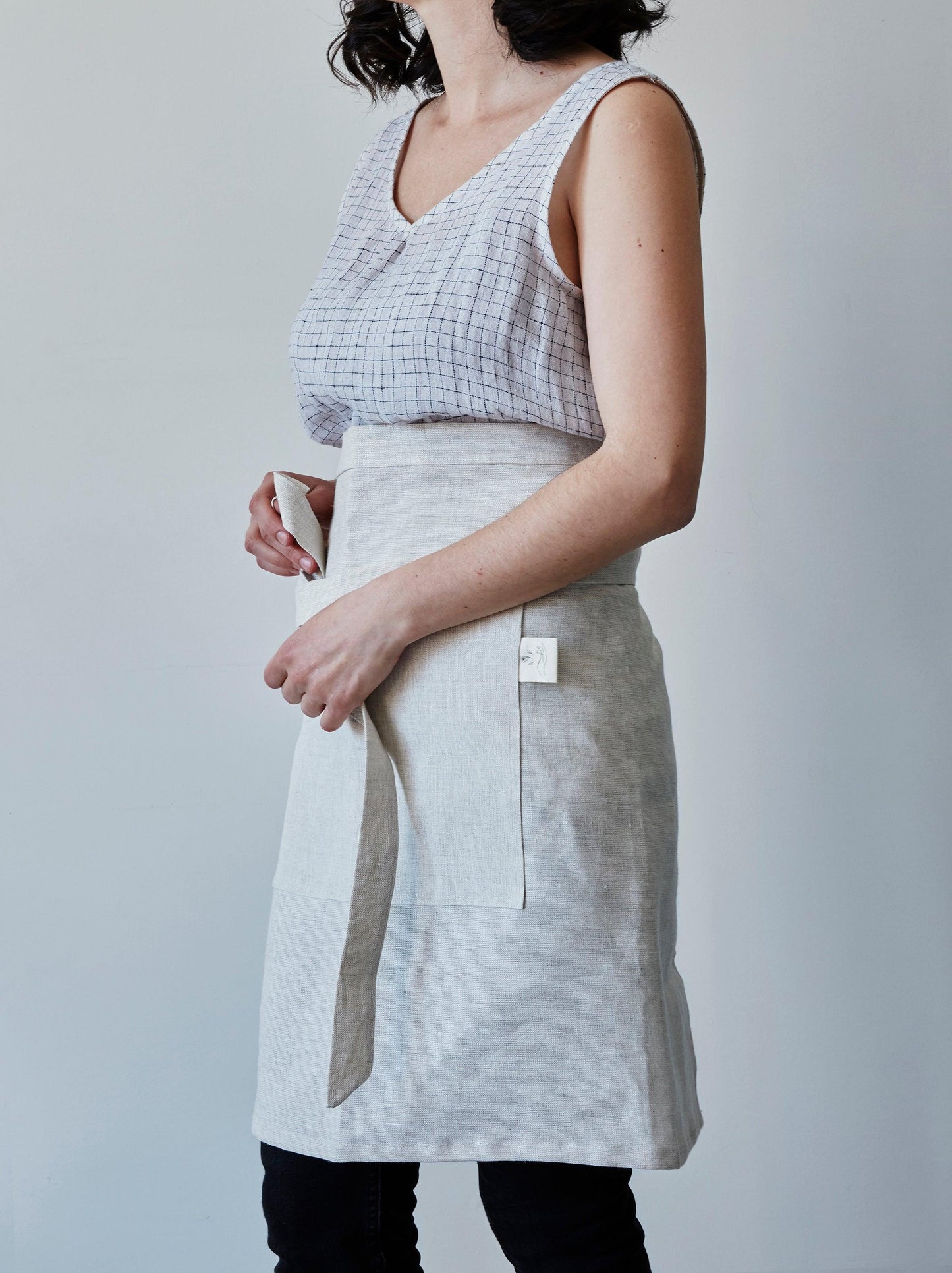 Front of our oat linen half apron with a view of the pocket