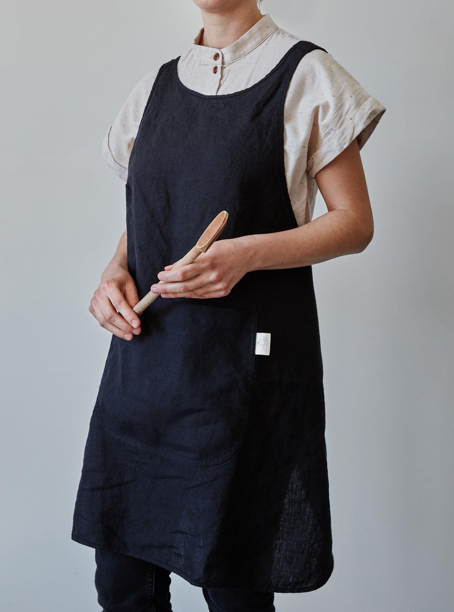 Front of our black linen apron with a view of the pocket