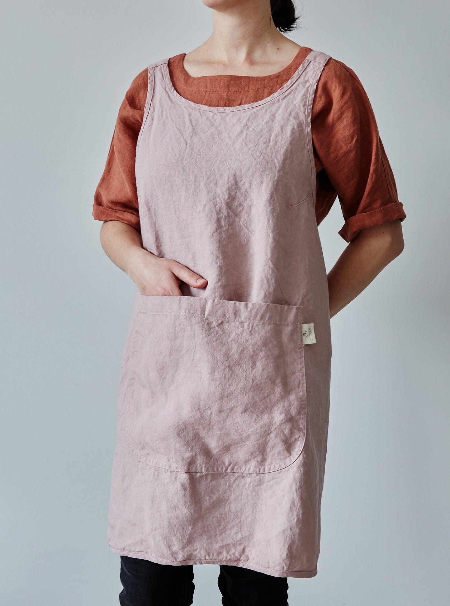 Front of our dusty rose linen apron with a view of the pocket