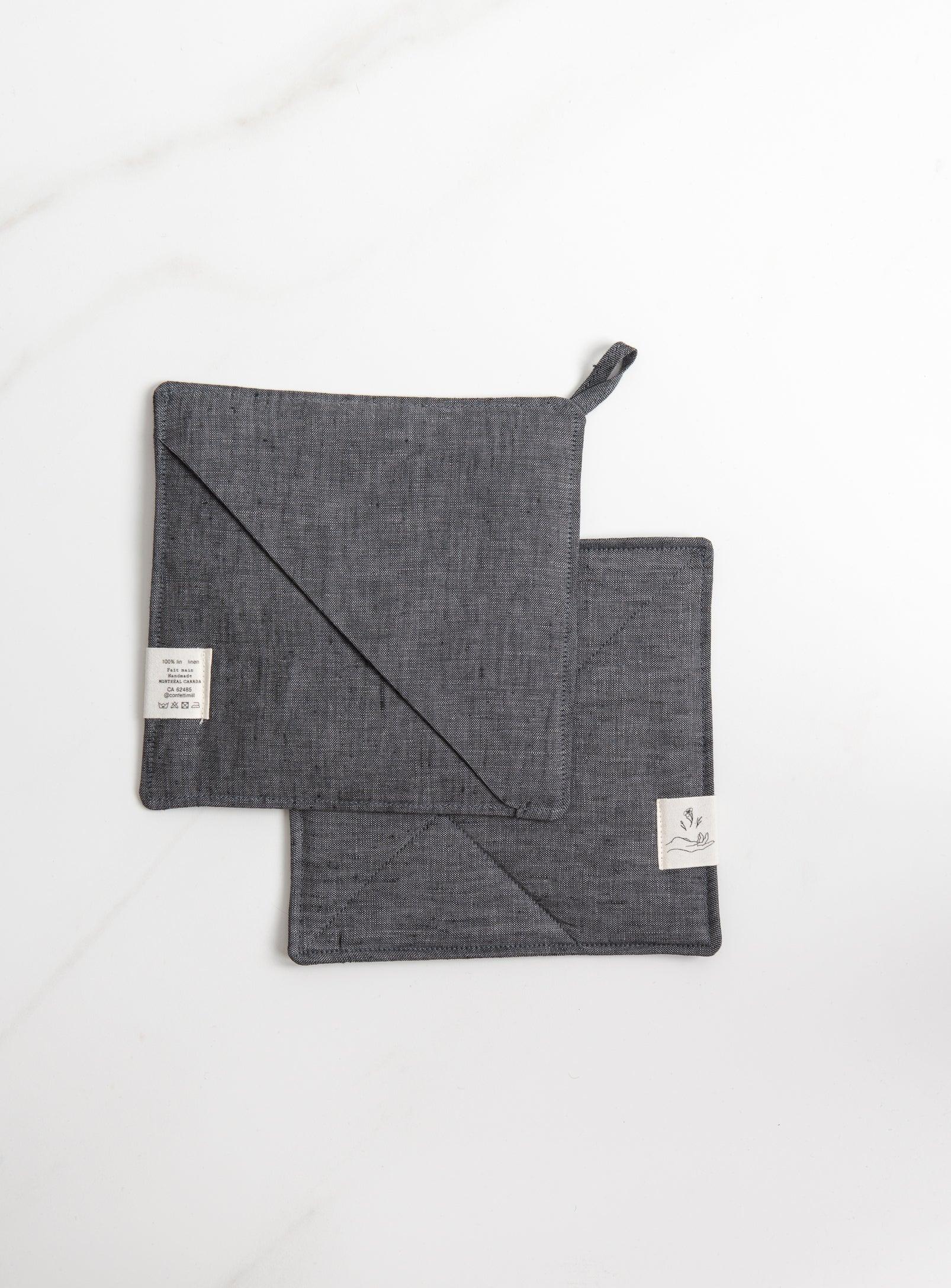 two grey trivets, one from front, one from back