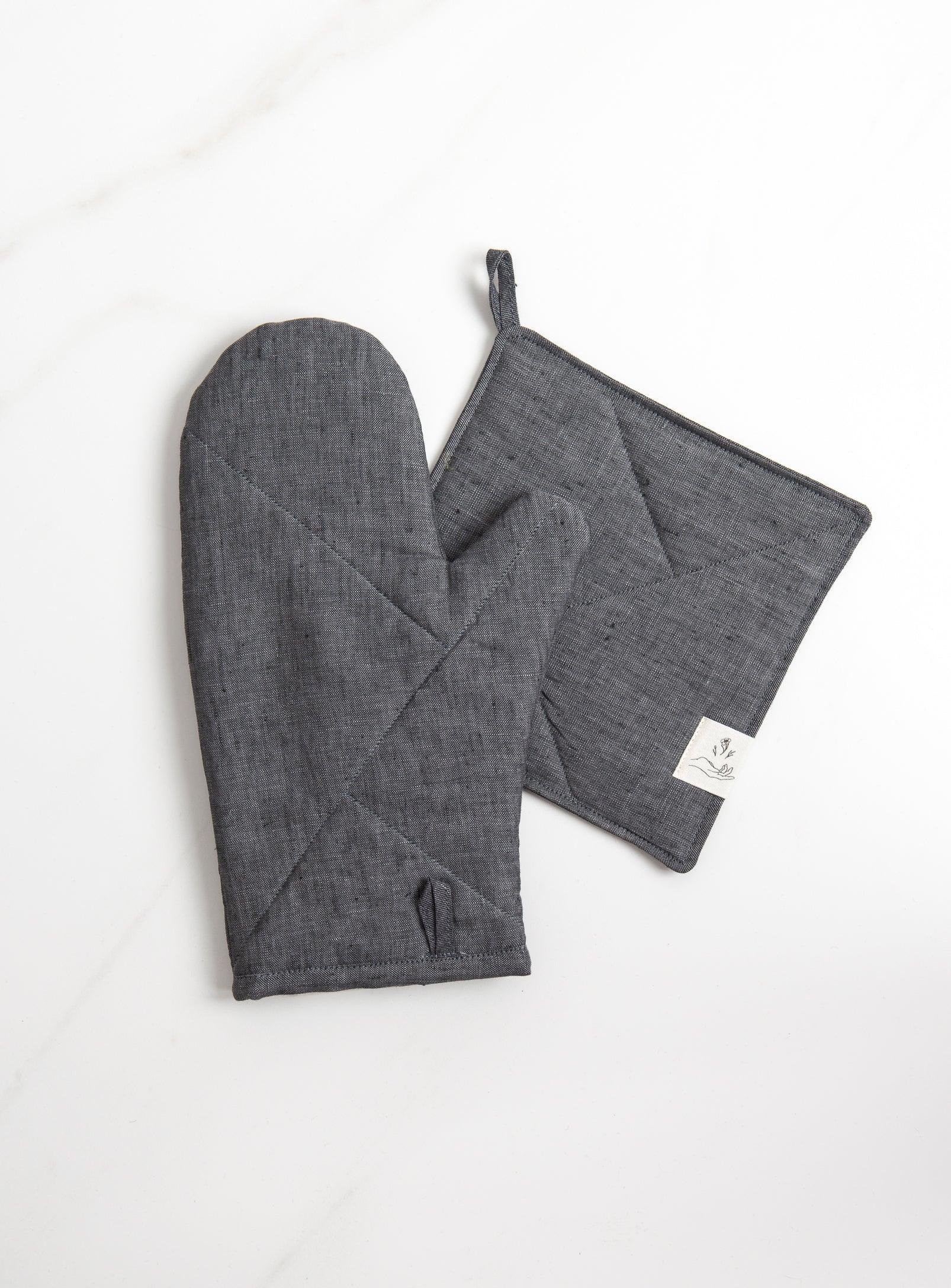 a grey oven mitt with a grey pot holder on white surface