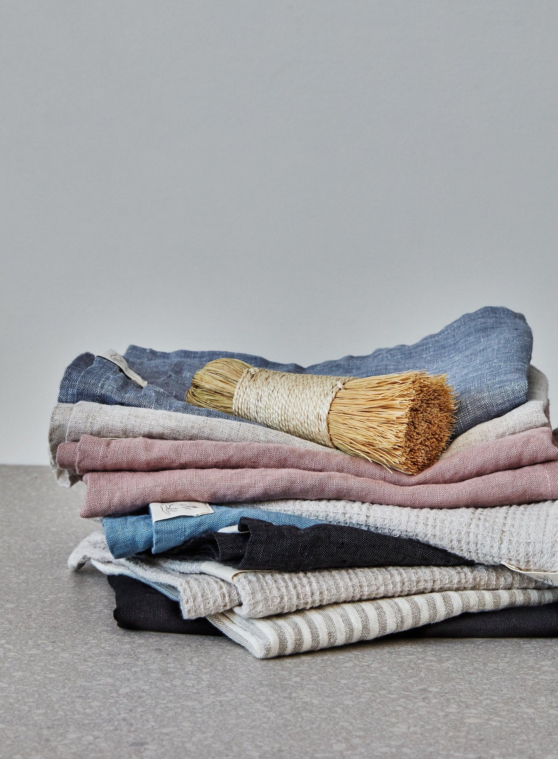pile of folded linen tea towels